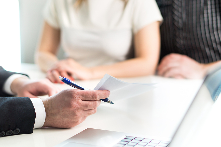 Couple having meeting with legal advisor regarding Liquidating Debt Efficiently